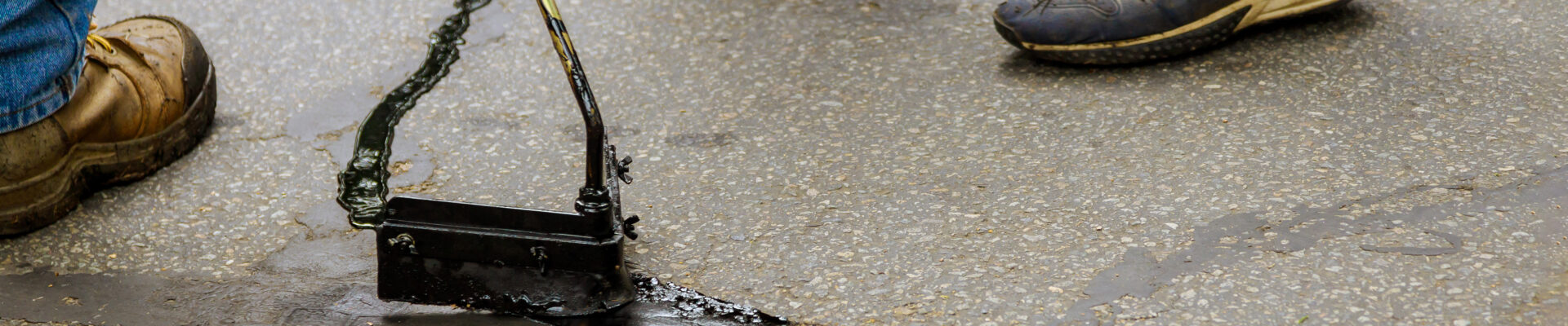 Asphalt-road-with-filled-cracks-repair-liquid-of-the-fix-road